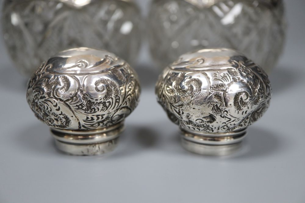 A pair of Edwardian repousse silver-mounted globular glass scent bottles, J.H. Worrel, Son & Co Ltd, Birmingham, 1907